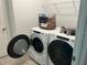 Bright laundry room features modern washer and dryer, and wire shelving at 8962 Hilton Ridge Ave, Kissimmee, FL 34747