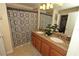 Bathroom featuring a double sink with granite countertops and a shower with patterned curtain at 8984 Cuban Palm Rd, Kissimmee, FL 34747