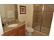 Bathroom featuring a vanity with granite countertops and a glass-door shower at 8984 Cuban Palm Rd, Kissimmee, FL 34747