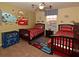 Bedroom with two beds, and a colorful Cars-themed wall mural at 8984 Cuban Palm Rd, Kissimmee, FL 34747