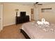 Bedroom featuring a dark wood dresser, a TV, and a bed with two swan towel art at 8984 Cuban Palm Rd, Kissimmee, FL 34747