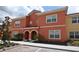 Beautiful condo featuring a modern design, well-maintained landscaping, and a welcoming facade at 8984 Cuban Palm Rd, Kissimmee, FL 34747