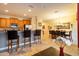 An open-concept kitchen and dining area with tile floors, stainless steel appliances, and seating at the kitchen island at 8984 Cuban Palm Rd, Kissimmee, FL 34747