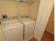 Laundry room with a washer and dryer and an ironing board at 8984 Cuban Palm Rd, Kissimmee, FL 34747