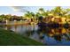 Picturesque pond view with a charming bridge, waterfall feature, and lush landscaping creating a serene atmosphere at 8984 Cuban Palm Rd, Kissimmee, FL 34747