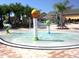 Community splash pad featuring playful water features and surrounding palm trees on a sunny day at 8984 Cuban Palm Rd, Kissimmee, FL 34747