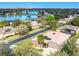 Home with a serene lake view from above, complimented by lush landscaping and screened lanai at 901 Shorehaven Dr, Poinciana, FL 34759