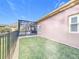 Exterior view showcasing the backyard, connecting to a screened in pool area, from the side of the house at 901 Shorehaven Dr, Poinciana, FL 34759