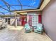 Inviting covered front porch with stylish stamped concrete and charming Adirondack chairs at 901 Shorehaven Dr, Poinciana, FL 34759