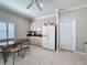 This kitchen features wood cabinets, a white refrigerator, a serving area, and a decorative dining table at 901 Shorehaven Dr, Poinciana, FL 34759