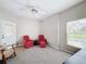 Cozy living room enhanced by soft carpet and a ceiling fan for optimal comfort and style at 901 Shorehaven Dr, Poinciana, FL 34759