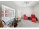 Bright living room featuring plush carpeting, ceiling fan, and two armchairs at 901 Shorehaven Dr, Poinciana, FL 34759