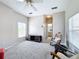 Bright living room featuring plush carpeting, ceiling fan, and a view into the bathroom at 901 Shorehaven Dr, Poinciana, FL 34759