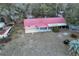 Aerial view of a charming single-story home with red roof, covered parking, and spacious yard at 912 Ne 144Th Ct, Silver Springs, FL 34488