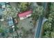 Overhead view of home with large roof and covered parking nestled among mature trees at 912 Ne 144Th Ct, Silver Springs, FL 34488