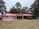 Charming single-story home with a red metal roof and covered parking at 912 Ne 144Th Ct, Silver Springs, FL 34488