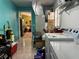 The laundry room features modern machines, with a view into the dining room and kitchen beyond at 912 Ne 144Th Ct, Silver Springs, FL 34488