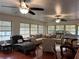 A brightly lit living room with hardwood floors provides ample seating and natural light at 912 Ne 144Th Ct, Silver Springs, FL 34488