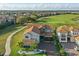 Beautiful aerial view of a home with a red tile roof, situated on a golf course community at 10196 Bucklow Hill Dr, Orlando, FL 32832