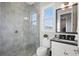 Bathroom featuring a glass-enclosed shower, modern fixtures, and tiled walls, creating a spa-like experience at 10196 Bucklow Hill Dr, Orlando, FL 32832