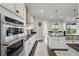 Modern kitchen with stainless steel appliances and a view into the living area with lots of natural light at 10196 Bucklow Hill Dr, Orlando, FL 32832