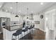 Modern white kitchen featuring a large island with bar stool seating and stainless steel appliances at 10196 Bucklow Hill Dr, Orlando, FL 32832