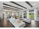 Bright living room featuring wood beams, hardwood floors, and a large white sectional sofa at 10196 Bucklow Hill Dr, Orlando, FL 32832