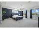 Stylish main bedroom with a tray ceiling, a dark accent wall, and large windows providing lots of natural light at 10196 Bucklow Hill Dr, Orlando, FL 32832