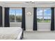 Main bedroom showcasing large windows, dark curtains, and natural light, creating a serene retreat at 10196 Bucklow Hill Dr, Orlando, FL 32832