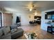 Open floor plan with tile flooring, views of the kitchen, and a dining table at 113 Las Brisas Way, Kissimmee, FL 34743
