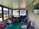 Enclosed sun room with ample seating, perfect for enjoying the outdoors indoors at 113 Las Brisas Way, Kissimmee, FL 34743