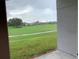 View of lush green backyard featuring golf course, neighboring houses and surrounding trees at 119 Southampton Dr, Kissimmee, FL 34744