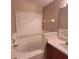 Bathroom features a tub, window with blinds, and a sink with vanity at 119 Southampton Dr, Kissimmee, FL 34744