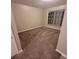 Neutral bedroom with tan carpet and blind covered windows at 119 Southampton Dr, Kissimmee, FL 34744