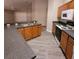 Kitchen features wooden cabinets and stone counter, with black appliances at 119 Southampton Dr, Kissimmee, FL 34744