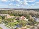 Stunning aerial view of estate home featuring beautiful landscaping and mature trees at 1211 Aquila Loop, Kissimmee, FL 34747