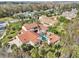 Stunning aerial view of a luxurious estate with a red tile roof, pool, and lush landscaping at 1211 Aquila Loop, Kissimmee, FL 34747