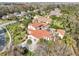 Luxury property aerial showcasing the terracotta roof, pristine lawn and mature trees at 1211 Aquila Loop, Kissimmee, FL 34747