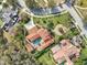 A birds eye view of a landscaped yard, brick drive and walkways and a private pool at 1211 Aquila Loop, Kissimmee, FL 34747