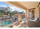 Inviting balcony view showcasing pool views, a cozy seating area, and wrought iron accents at 1211 Aquila Loop, Kissimmee, FL 34747