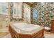 Close-up view of the soaking tub with luxurious wooden trim and granite top at 1211 Aquila Loop, Kissimmee, FL 34747