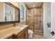 Bathroom featuring a vanity with granite countertop and glass enclosed shower at 1211 Aquila Loop, Kissimmee, FL 34747