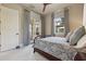 Bright bedroom with french doors and plush bedding showcasing serene ambiance and design at 1211 Aquila Loop, Kissimmee, FL 34747