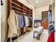 Well-organized walk-in closet with custom shelving, drawers, and bench at 1211 Aquila Loop, Kissimmee, FL 34747