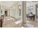 Elegant dining room with travertine flooring, large windows, and a modern chandelier for sophisticated gatherings at 1211 Aquila Loop, Kissimmee, FL 34747