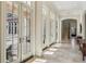 Bright and airy foyer features travertine flooring, French doors, and views of the outdoor living space at 1211 Aquila Loop, Kissimmee, FL 34747