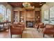 Inviting living room with wooden ceiling, custom built-ins, fireplace, and natural light at 1211 Aquila Loop, Kissimmee, FL 34747