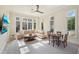 Living room with a beige sectional sofa, breakfast table and abundant sunlight from the many large windows at 1211 Aquila Loop, Kissimmee, FL 34747