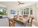 Sunlit living room showing breakfast table, beige sofa, view of patio and an expansive view of exterior greenery at 1211 Aquila Loop, Kissimmee, FL 34747