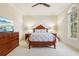 Main bedroom featuring elegant wood furniture and a large window at 1211 Aquila Loop, Kissimmee, FL 34747